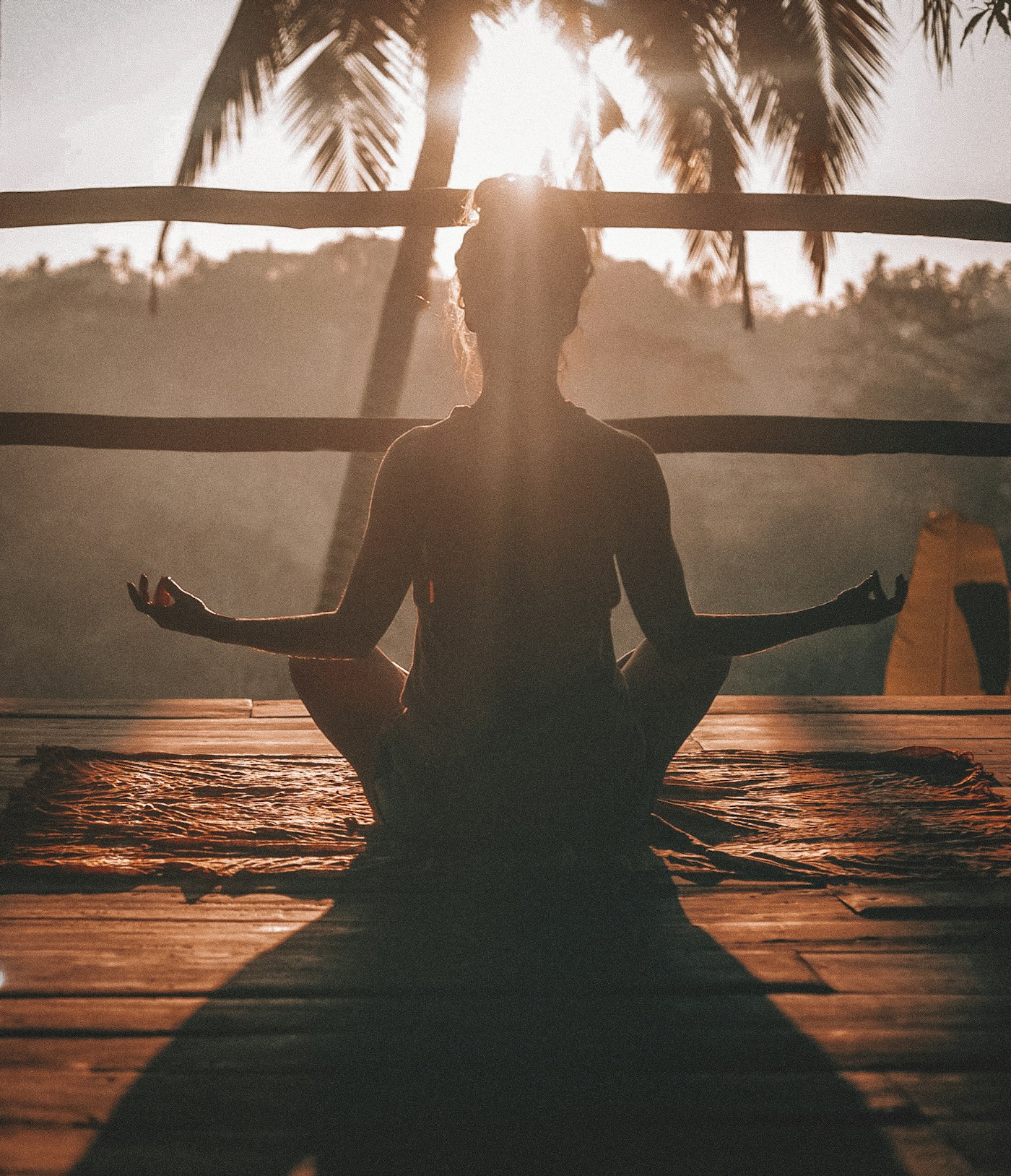 Person sitting calmly at sunrise